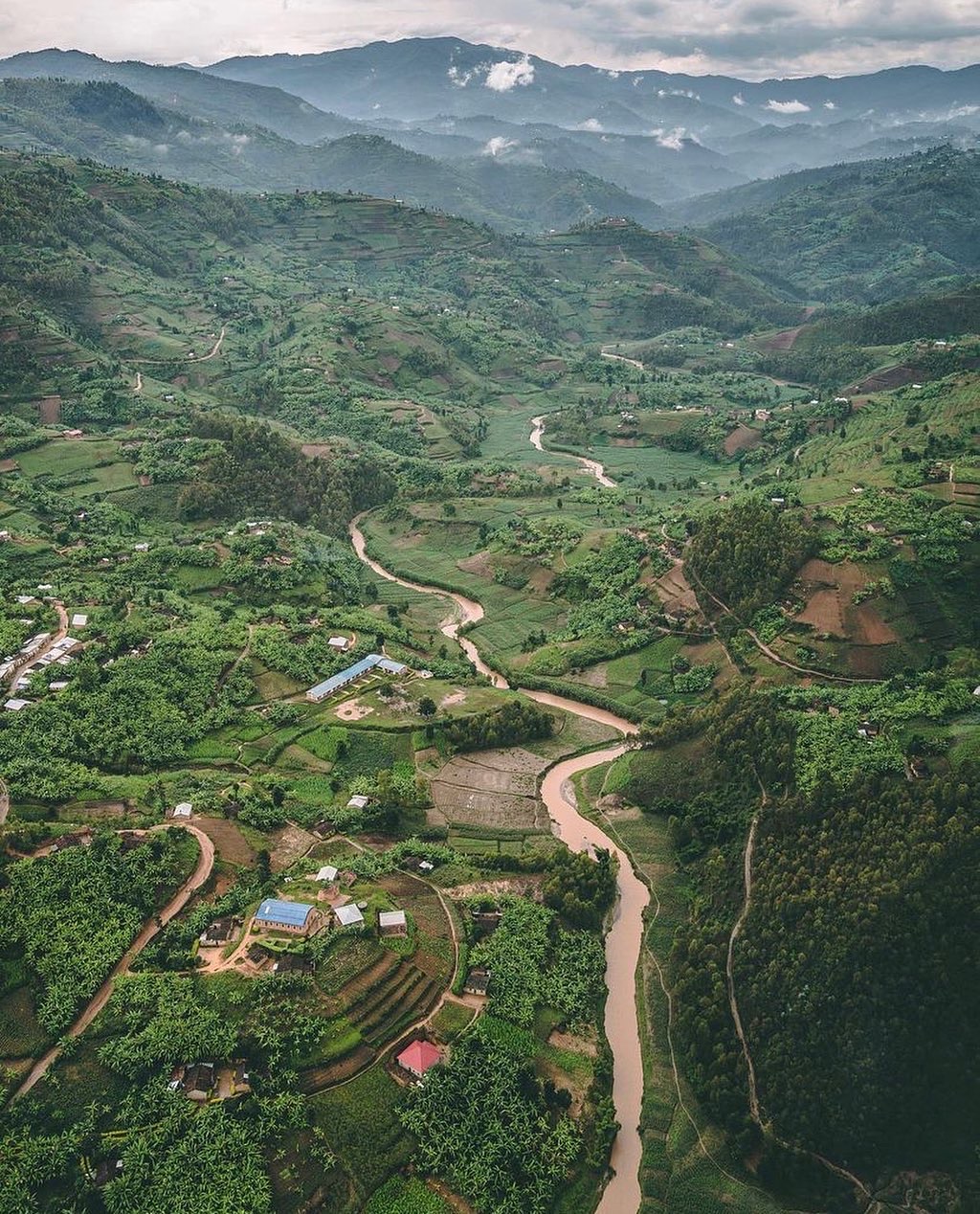 Aerial view of a river valley and terraced hills in Rwanda
