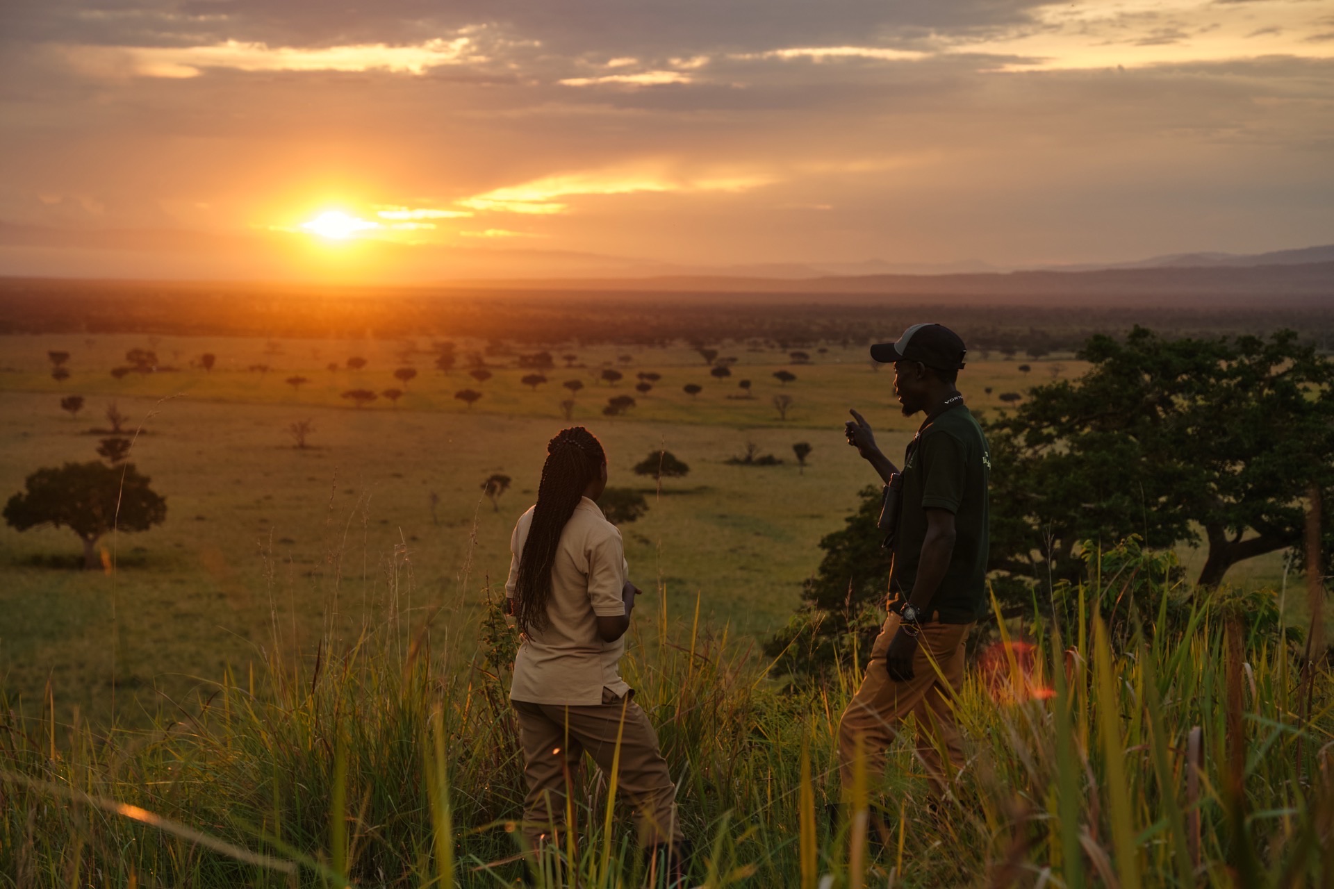 Guide and guest at sunset in Queen Elizabeth National Park, Uganda