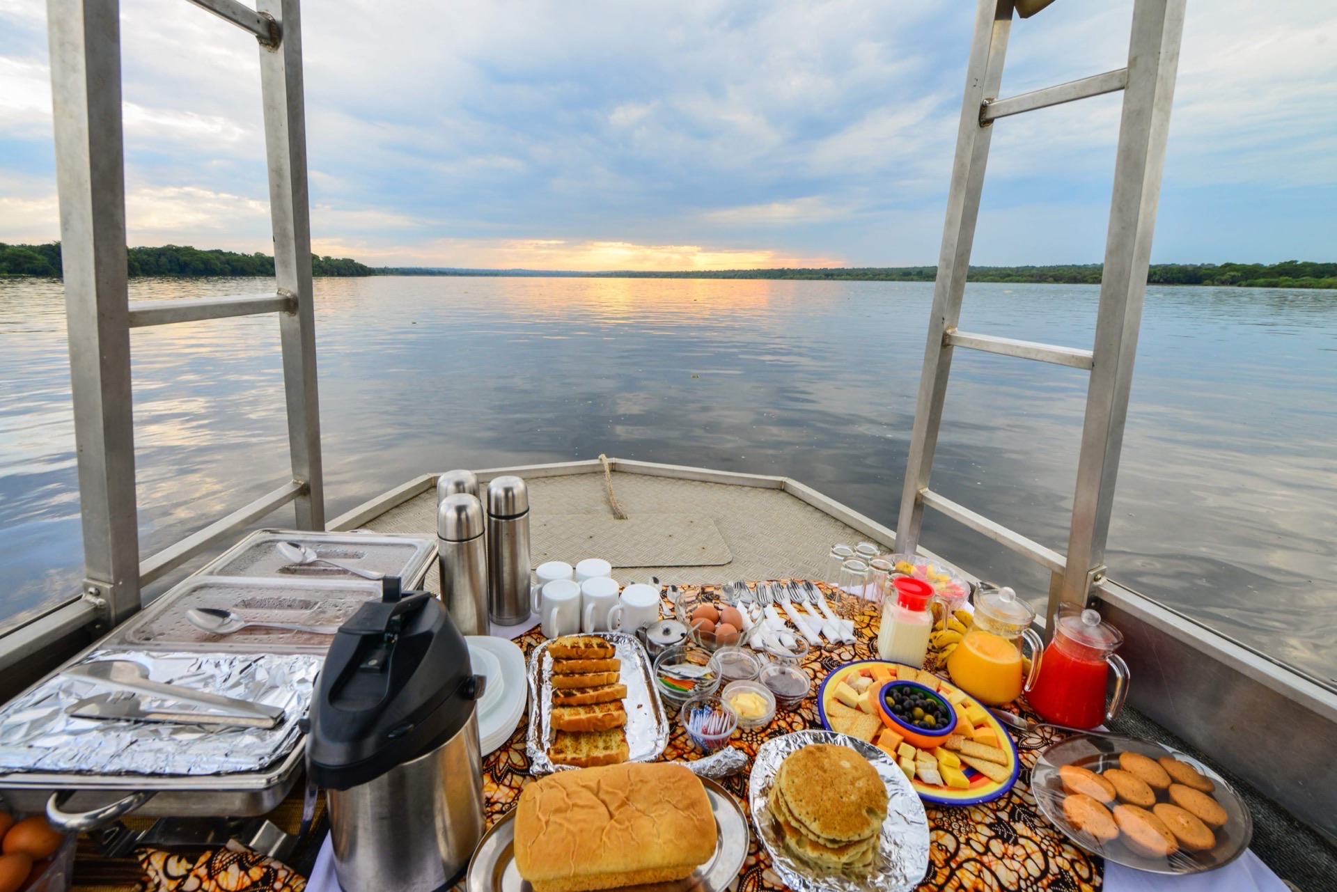 Breakfast laid out on a boat at sunset on the Victoria Nile